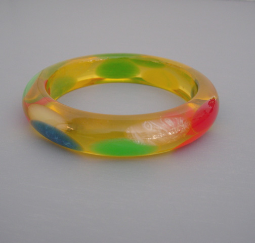 SHULTZ bakelite apple juice bangle with translucent oval dots in several colors and a misty feel