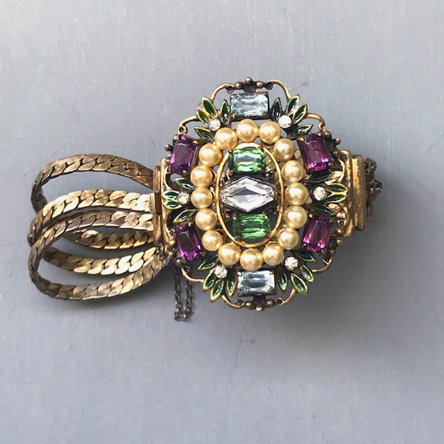 DEROSA bracelet with purple, pale blue, green and clear rhinestones and glass pearls and accented with tiny green enameled leaves at the edge