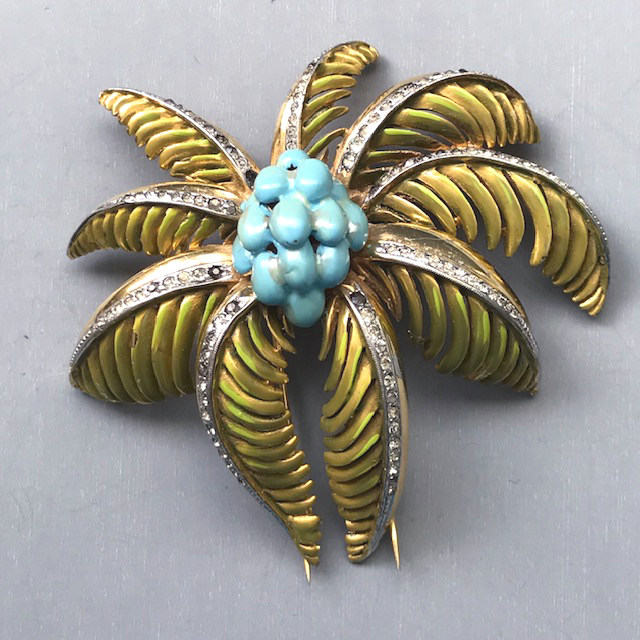 DEROSA fur clip with green enameled palm tree leaves and aqua enameled coconuts accented by clear rhinestone veins