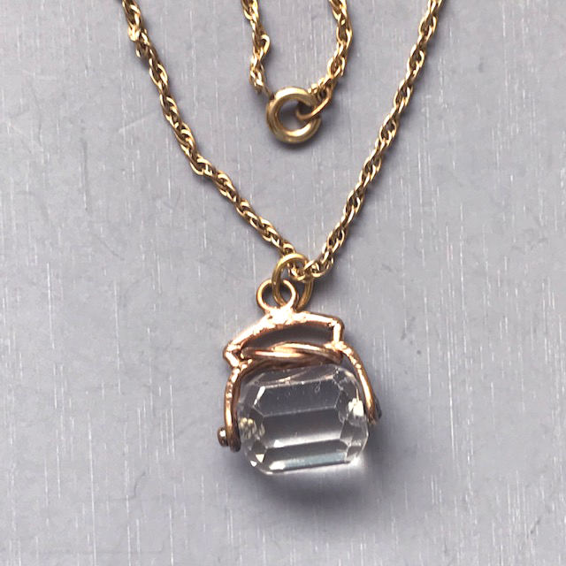 VICTORIAN rock crystal spinning barrel fob in a 14k setting on a gold filled 19″ chain