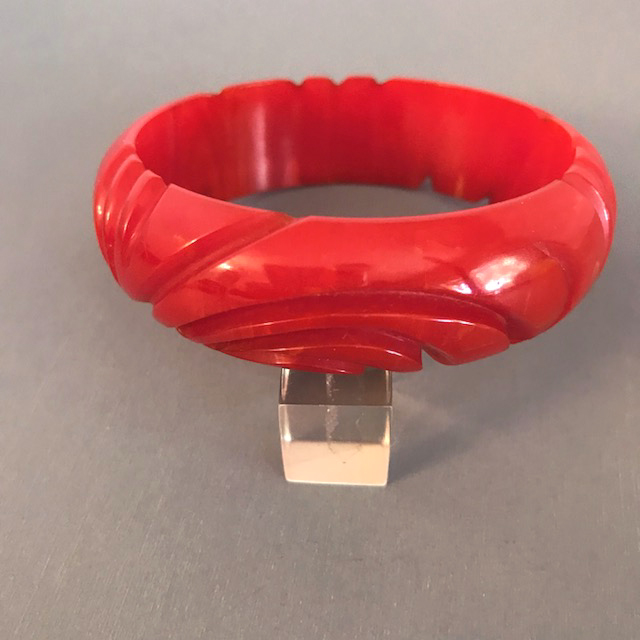 BAKELITE apple red swirl carved bangle, a luscious color