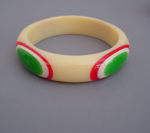 SHULTZ bakelite cream bangle with red, white and green bull’s eye dots