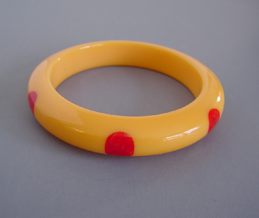 SHULTZ bakelite peachy-yellow color bangle with red dots