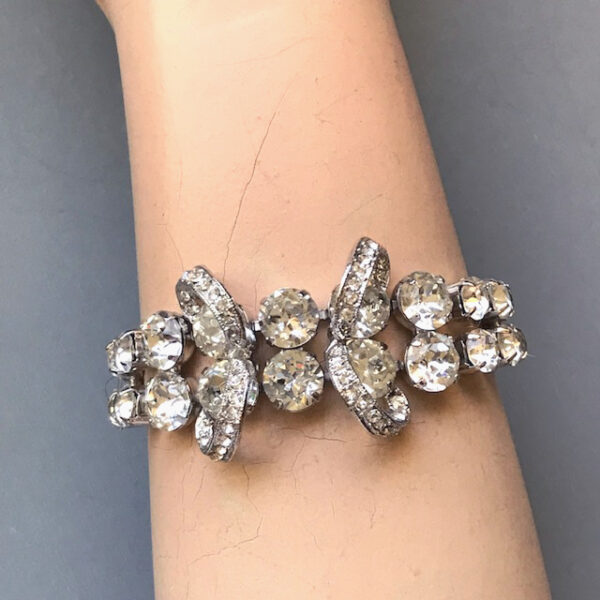 EISENBERG dazzling clear rhinestones bow bracelet in a silver colored rhodium plated setting